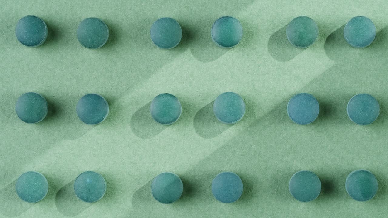 Green mint mentol lollipops, candies, bonbons disappear on purple background. Summer bright texture studio shot for store, supermarket, close up top view. Children favorite sweets made of sugar.