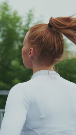 a young woman in athletic wear jogging outdoors amidst lush greenery, capturing the energy and joy of running in a natural setting