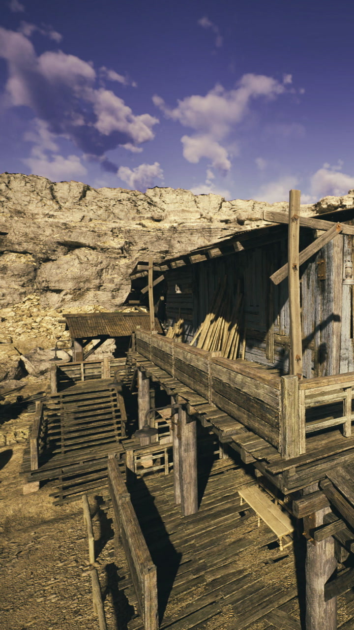 Rustic wooden structures nestled in a rocky landscape under a vast blue sky