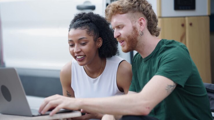 Couple Using Laptop Outdoors