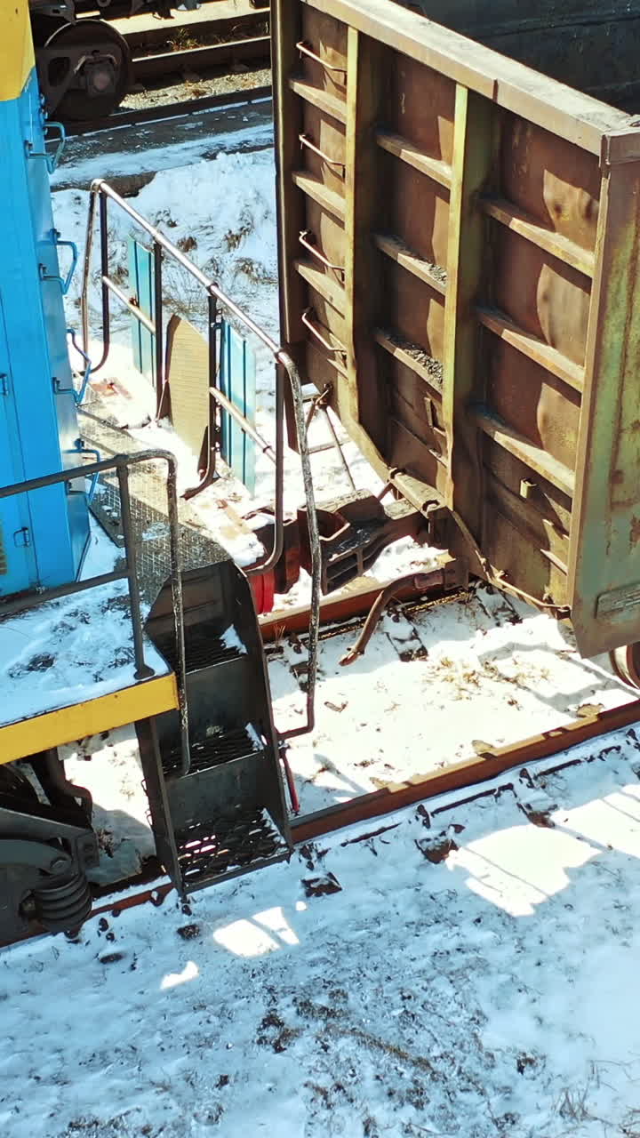 Cargo train platform with container. Scenic aerial view of mixed freight train at platform. Vertical video