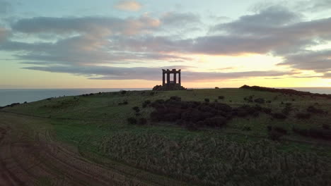 Aerial-footage-of-Stonehaven-War-Memorial-at-sunrise,-Aberdeenshire,-Scotland