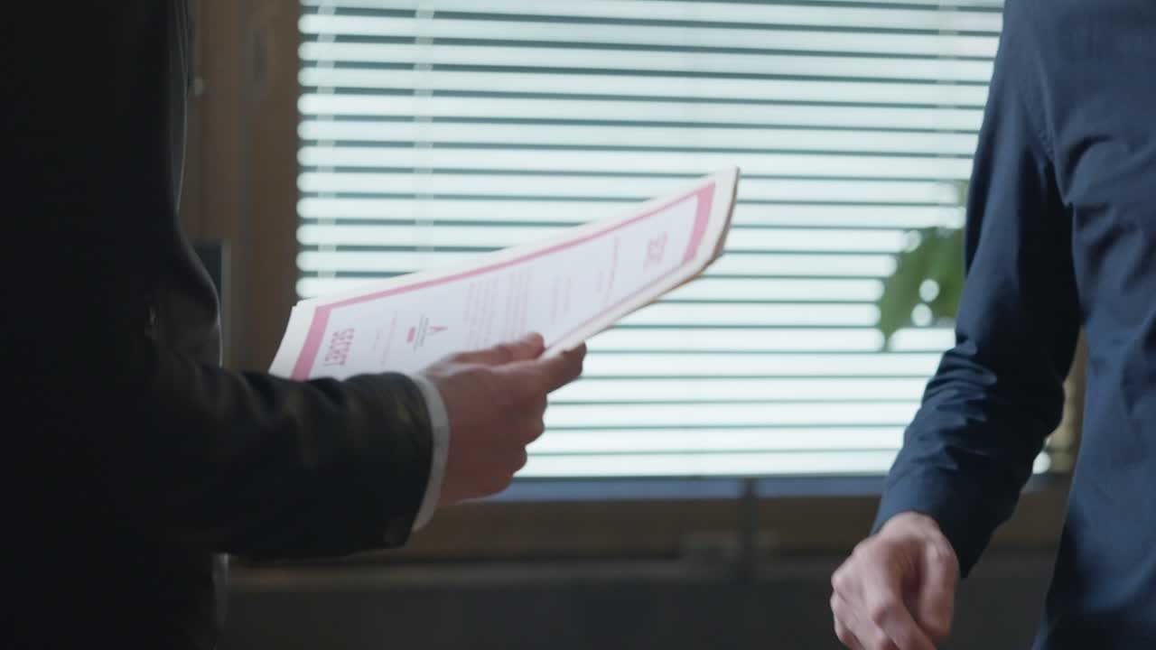 Confidential secret folder exchange, two men passing secret material. sealing the covert transaction with a firm handshake. Espionage, secrecy and conspiracy, corporate fraud, intelligence trade.