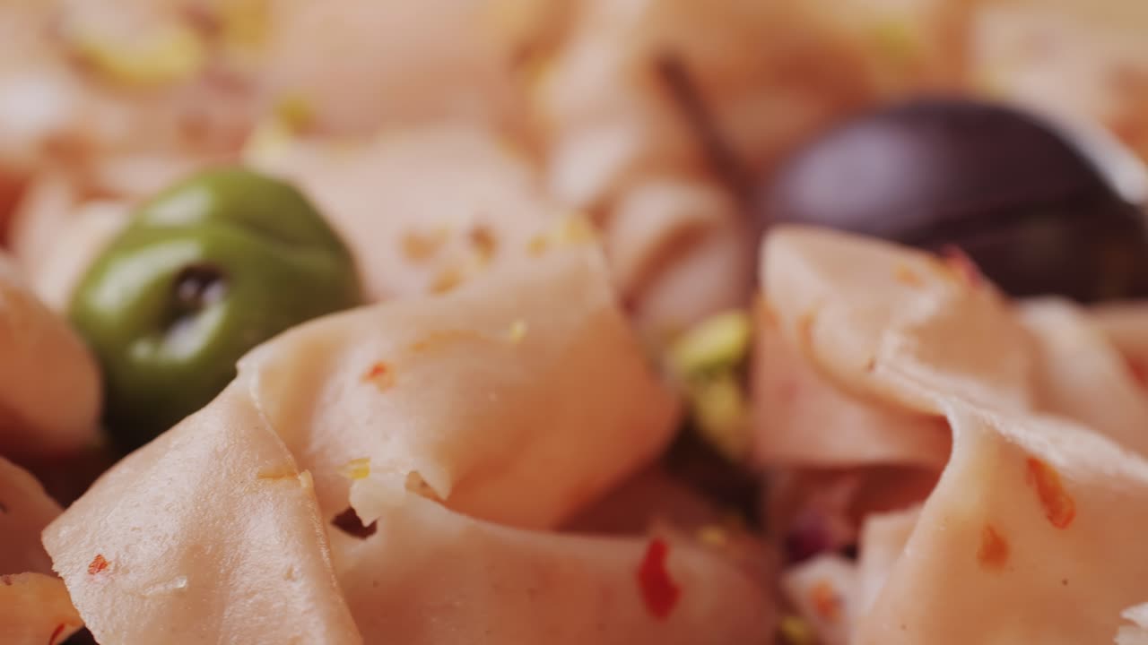 Ham italian mordatella, man Slices Of Traditional Italian antipasti mortadella sausage on a wooden cutting board, close up macro of chicken or turkey jamon, fat breakfast dish.