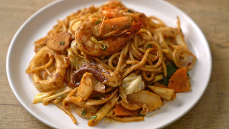 stir fried tom yum seafood dried spaghetti - fusion food style