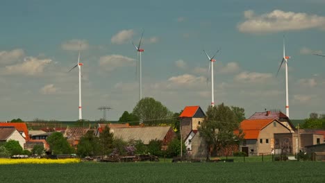 wind electric turbines in agricultural wheat field in countryside. deutchland.