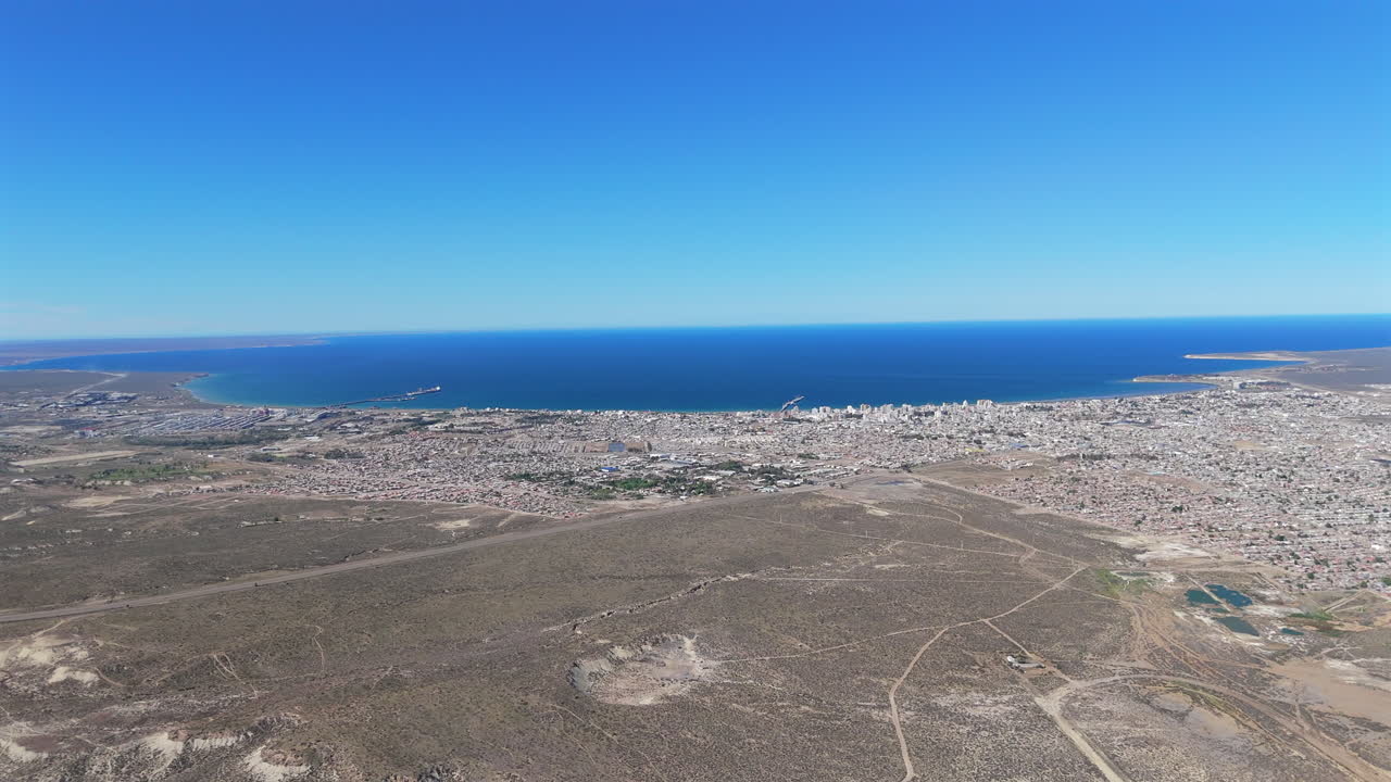 Gulf city ocean horizon skyline aerial view of land buildings and shore in Puerto Madryn Argentina Golfo Nuevo