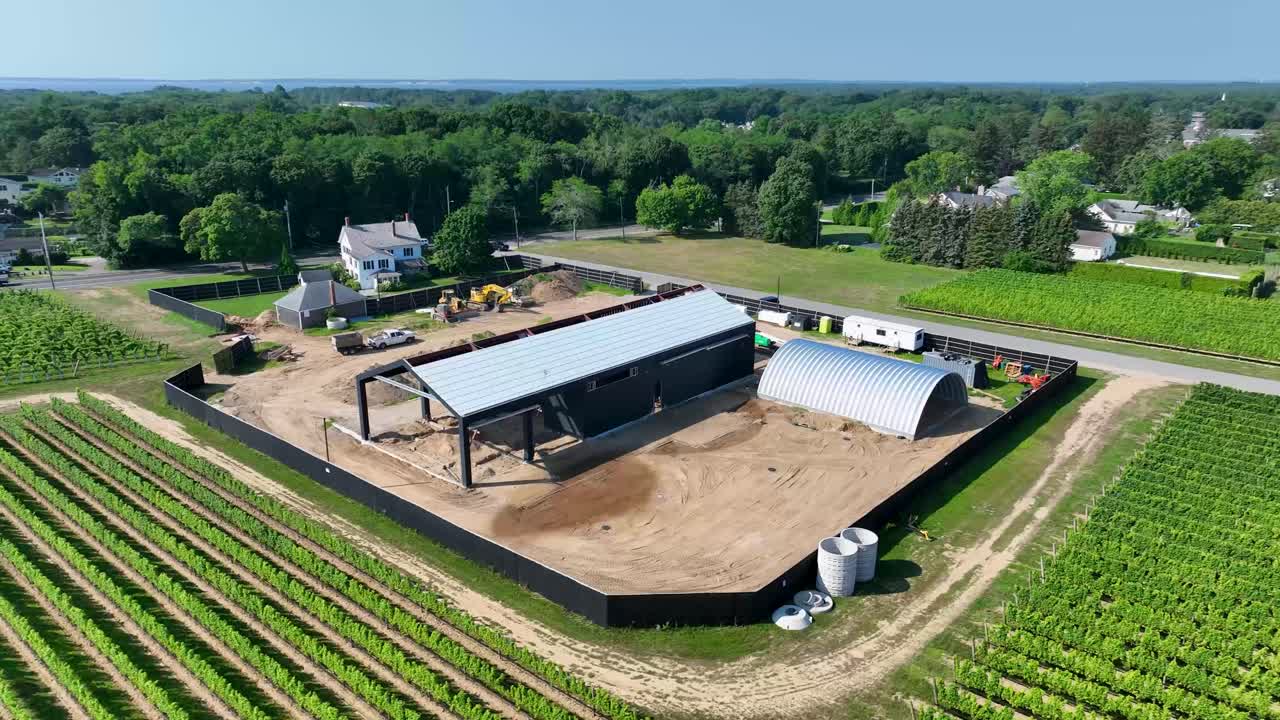 drone flying over a construction site with blue sky above it
