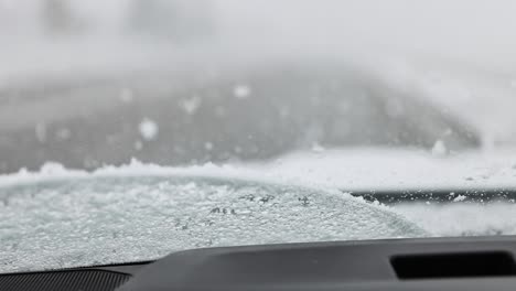 windshield wiper on a truck from the inside looking out wiping away heavy snowfall in a winter storm 60fps