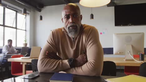 portrait of african american businessman looking at camera at office