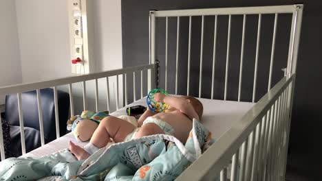 baby playing with ball in a hospital bed