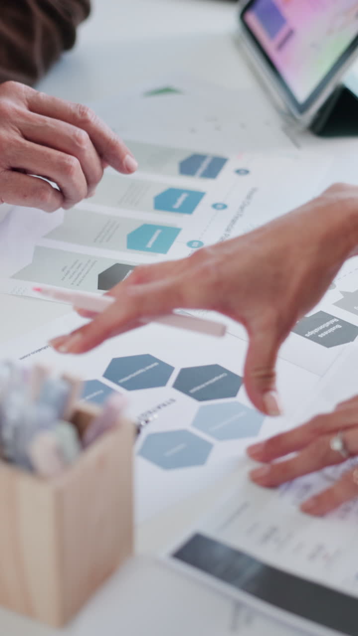 Close-up of Business Hands Analyzing Financial Documents and Charts