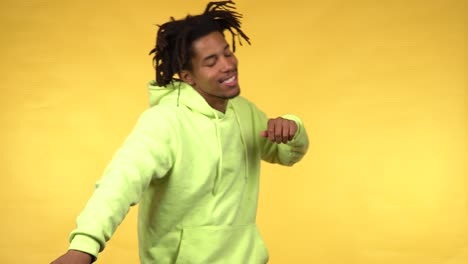 a young black male man in a green hoodie smoothly dancing