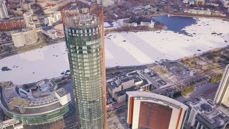 aerial view of a modern skyscraper in a city during winter