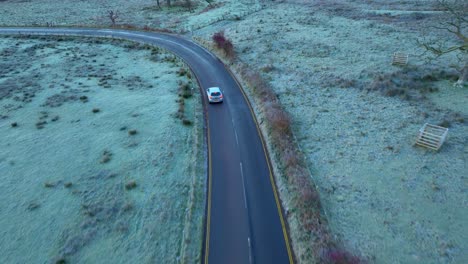 Flying-low-over-road-with-car-appearing-from-bottom-of-frame