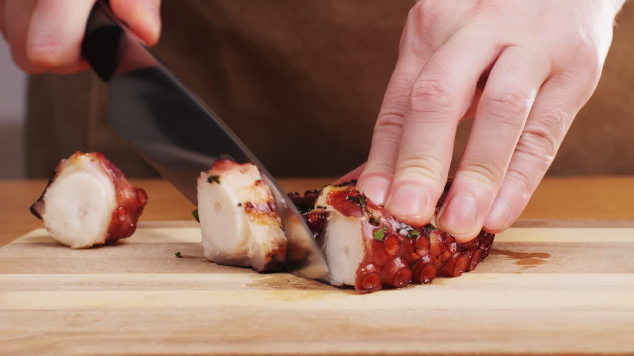 Octopus cooking, chef grill fresh octopus galician style on restaurant kitchen, healthy food, seafood cafe in spain, traditional asian japanese spanish and mediterranean dish.