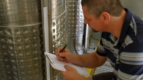 male worker writing on a clipboard 4k