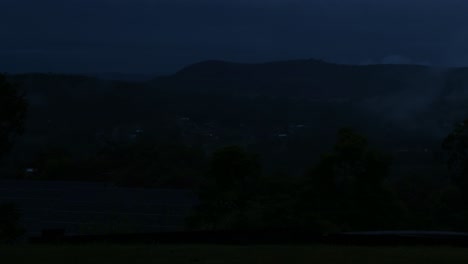 time-lapse of foggy mountains as night falls