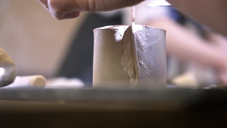 sculpting clay with a knife