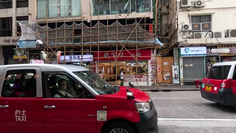 cars and pedestrians on a bustling hong kong street