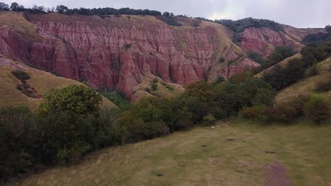 Vista-Aérea-Panorámica-Del-Pintoresco-Cañón-Con-Rocas-De-Arenisca-Roja-En-Un-Día-Nublado-Claro