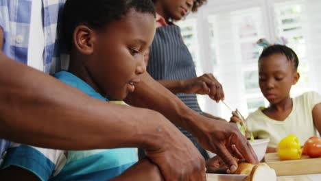 happy family preparing food in kitchen