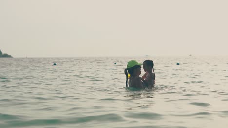 silhouettes-of-mother-and-daughter-playing-in-tranquil-ocean