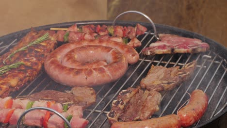 traditional spanish barbeque, big sausage chorizo botifarra, pork and beef ribs on grill with fire, american style cooking, chef grilling meat fat food, steaks and sausages on bbq. high quality 4k footage