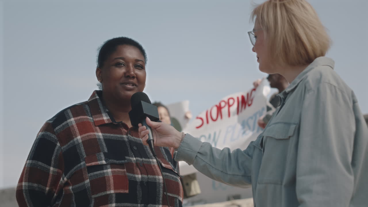 TV Reporter Interviewing Environmental Activist on Protest