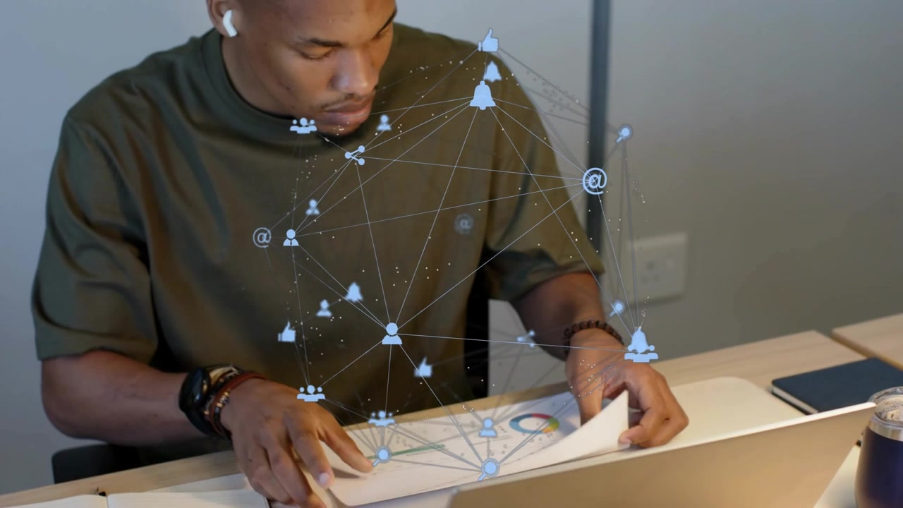 Man placing sheet on laptop, flipping pages and reading charts, AR overlaying marketing workspace