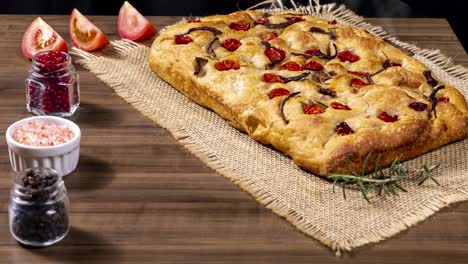 traditional italian focaccia with pepperoni, cherry tomatoes, black olives, rosemary ando onion - homemade flat bread focaccia