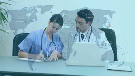 animation of data processing with world map over diverse doctors using laptop