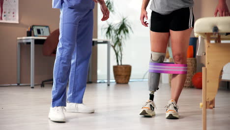 physical therapist working with patient with prosthetic leg