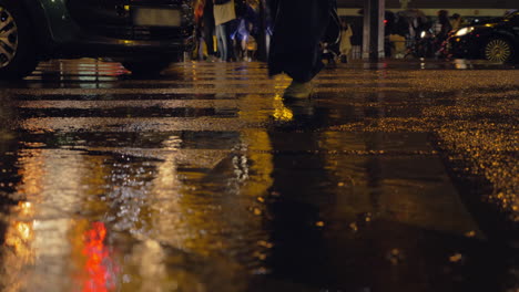 rainy evening in the city people crossing the road