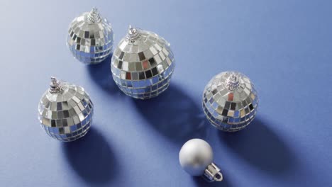 Video-of-silver-bauble-and-mirror-balls-on-blue-background