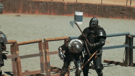 slow motion track shot of battle between old knights in armor