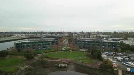elevated drone footage of mariner square, highlighting the serene marina surrounded by alameda's vibrant waterfront activities.
