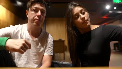 couple solving a puzzle in a cafe