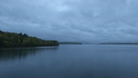 stunning walking hyper-lapse of a dark, atmospheric foggy rainy lake in the appalachian mountains