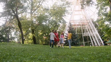 Four-people-talking-and-walking-in-a-park