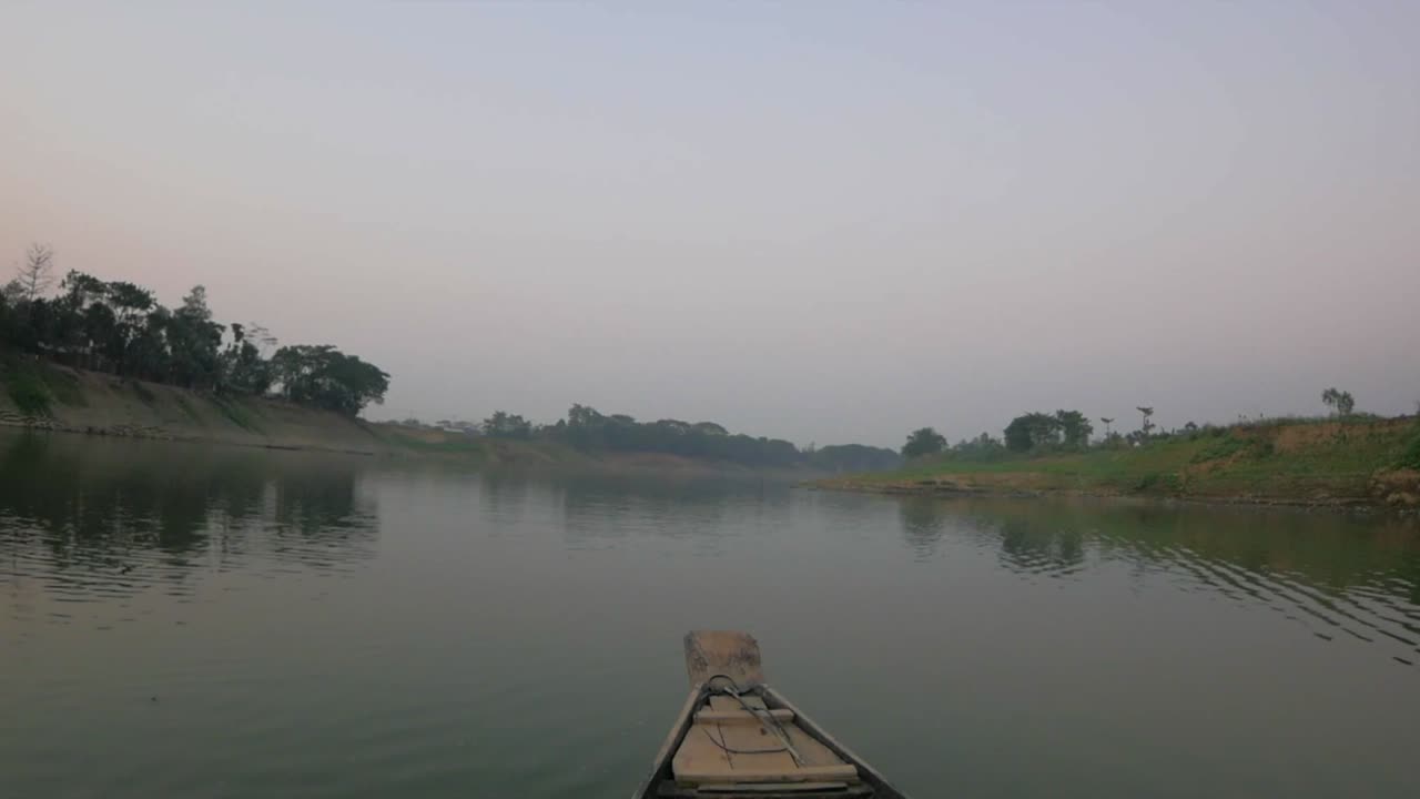 Bow of a small boat as it transported a small group of people from one side of a river to the other.
