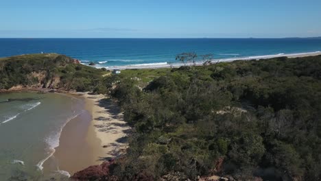 Aerial-backward-circling-of-wild-coast-near-Red-Rock-village