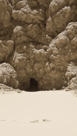 a cave entrance in a desert landscape