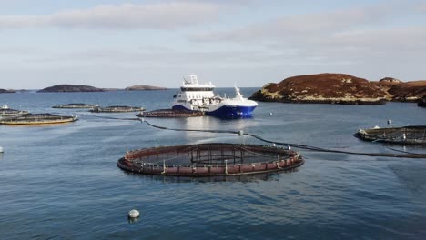 low altitude drone shot over the sea surrounding a hebridean fish farm