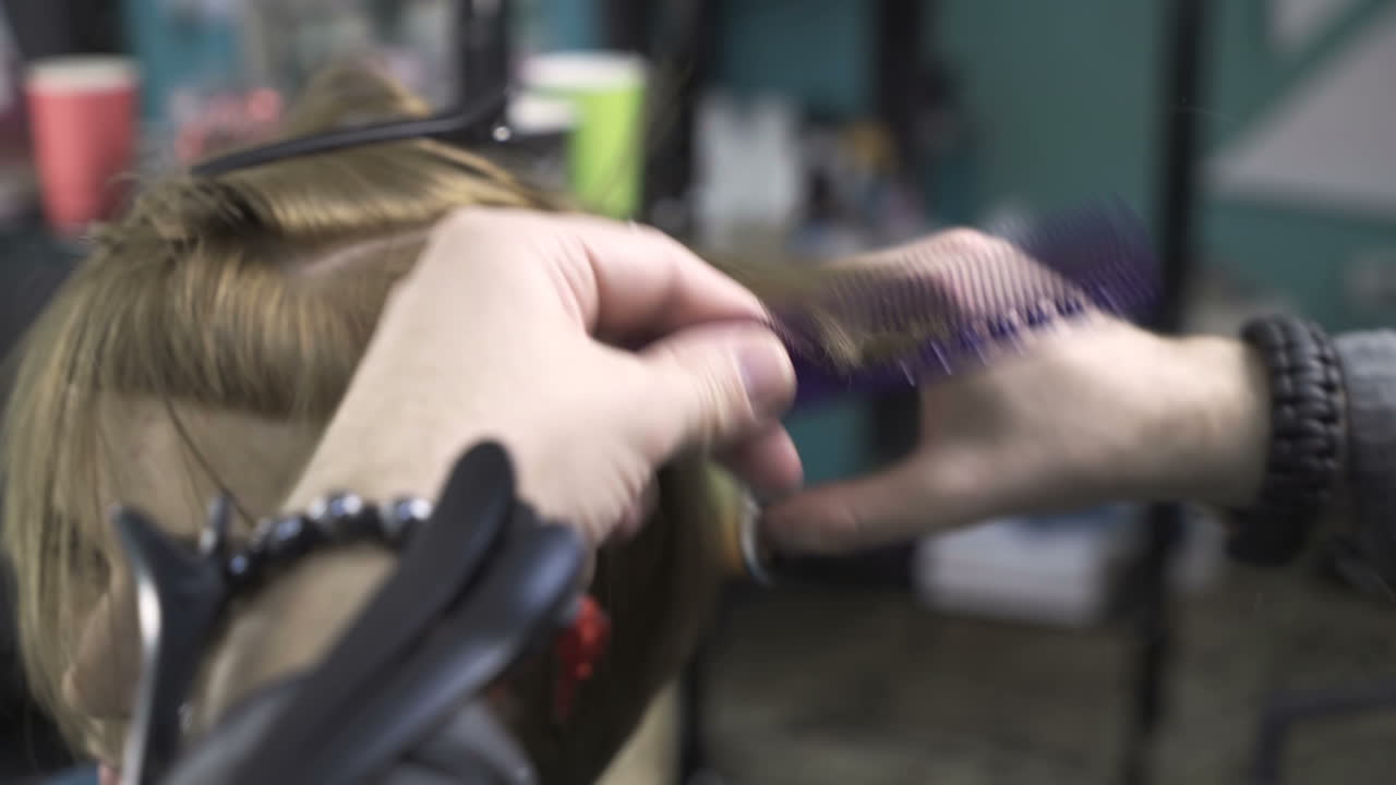 Hairdresser cutting hair. Stylist cutting woman hair in salon pool
