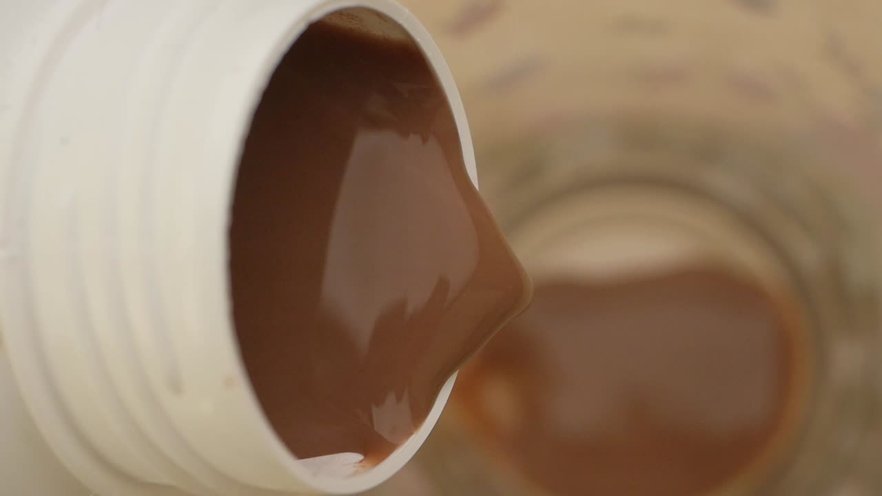 Pouring chocolate milk from a container
