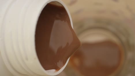 pouring chocolate milk from a container