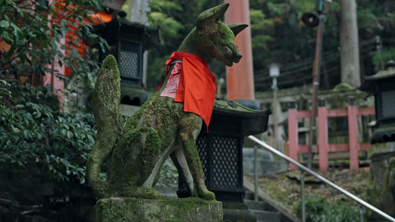 A stone dog statue stands proudly at Fushimi Inari Shrine in Kyoto, Japan.