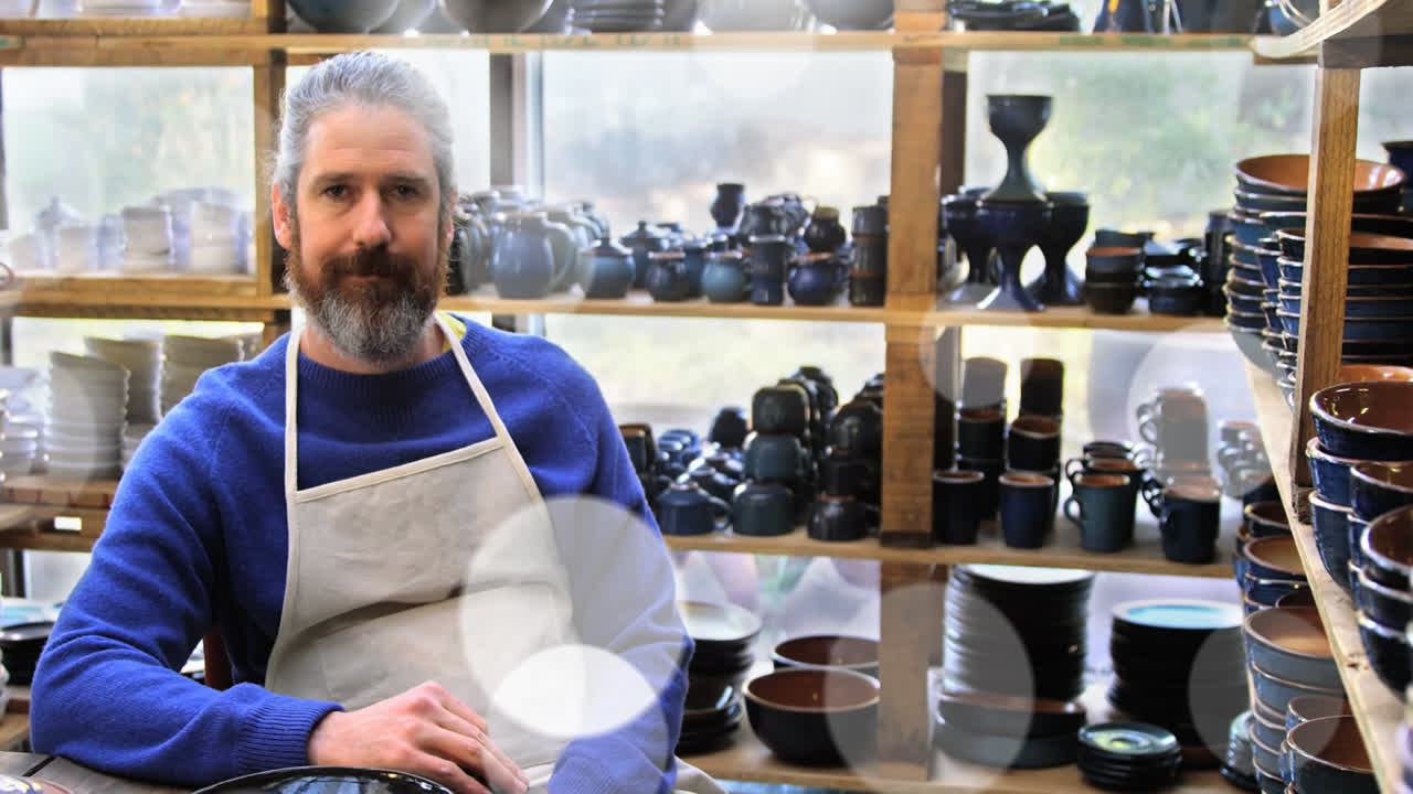 animación de luz brillante sobre el hombre caucásico trabajando en el taller del alfarero