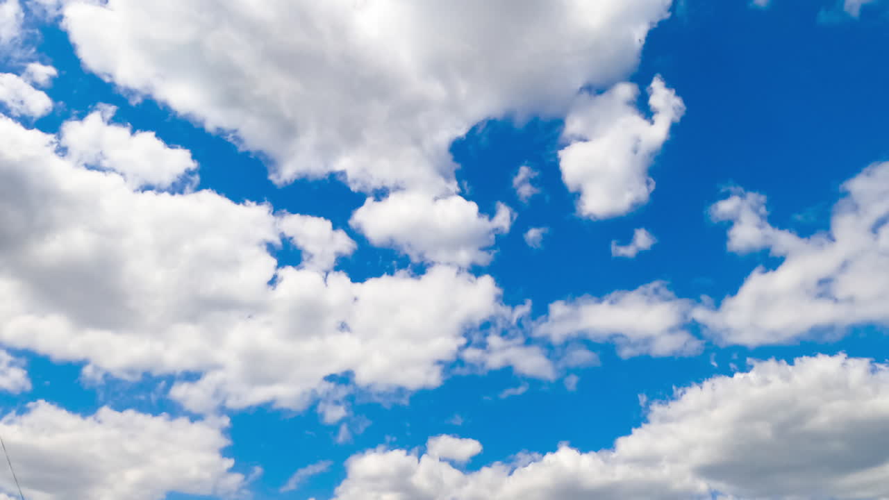 Soft white clouds transforming in the azure skies. Beautiful cloudscape moving timelapse.